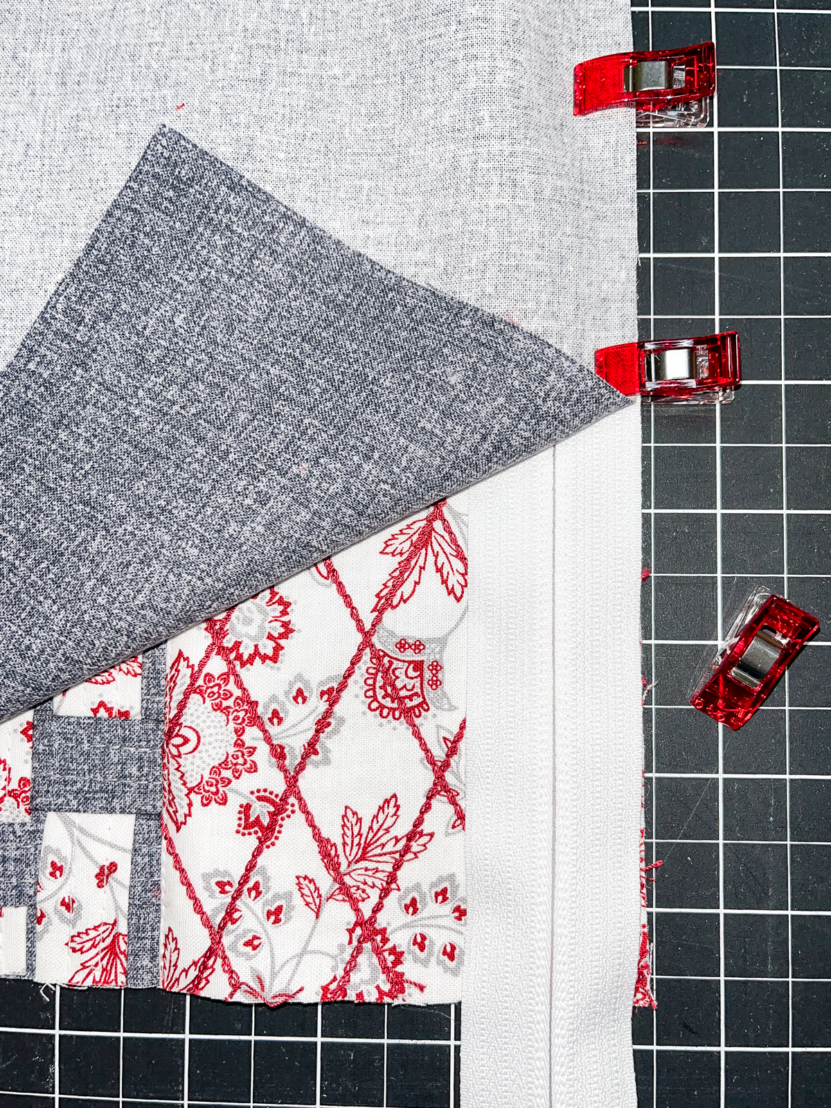 Overhead view of a zipper being clipped to fabric