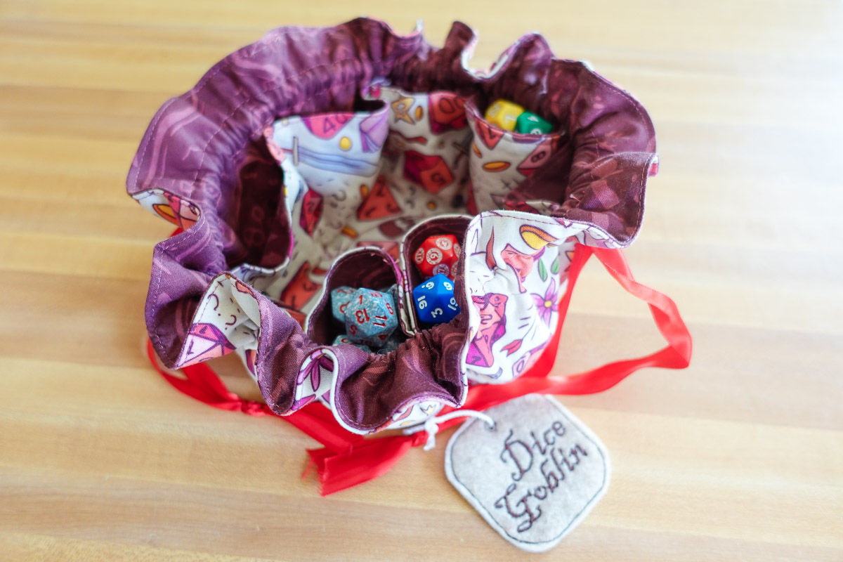 A handsewn DND dice bag with dice inside