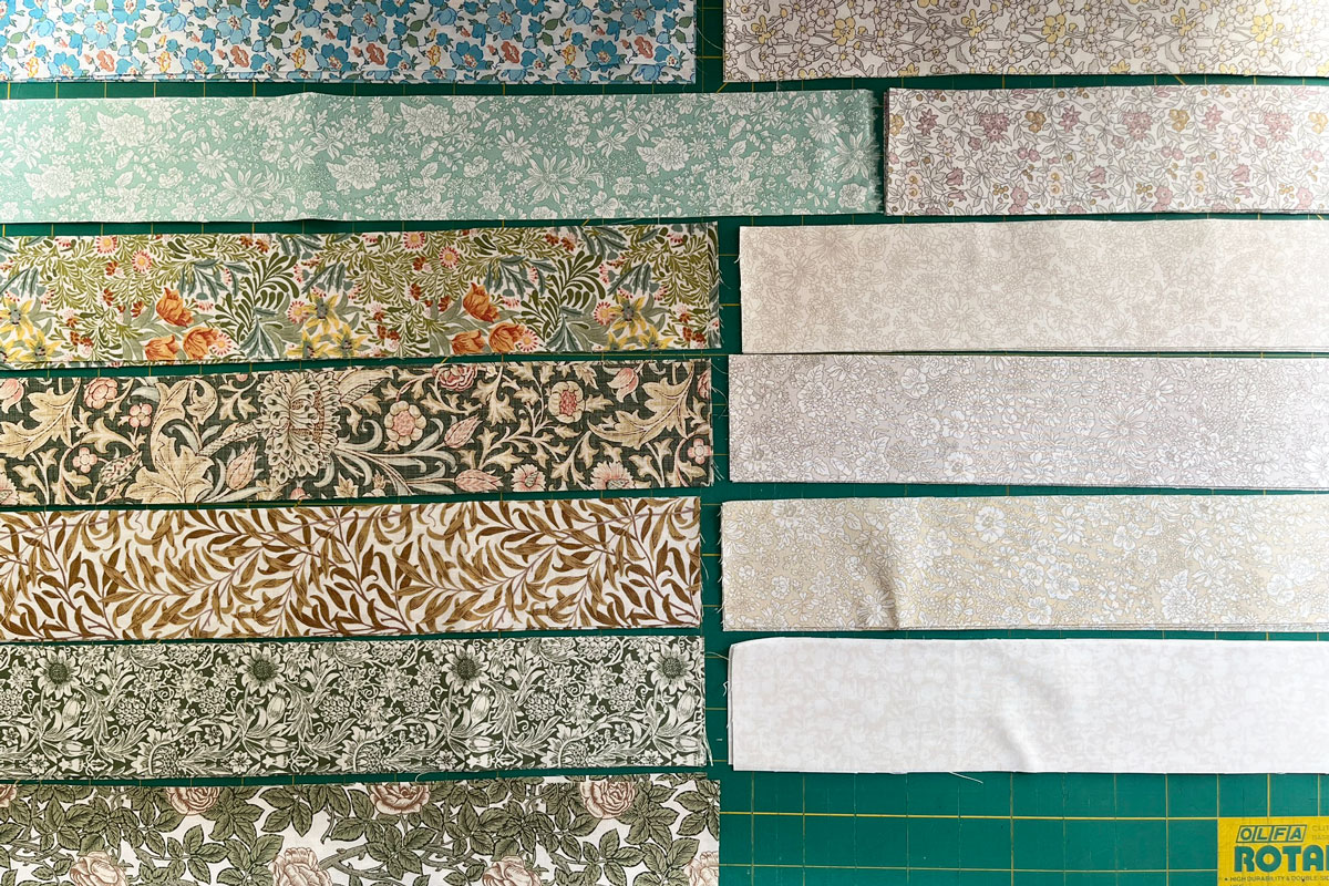 2.5" width strips of fabric cut in preparation for strip piecing.