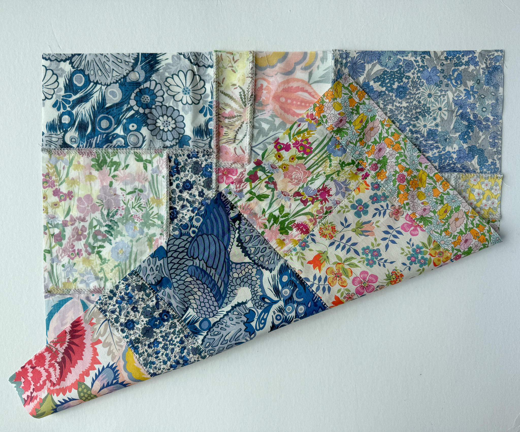 The front and back of a patchwork made using a flatlock stitch and scraps of Liberty Tana Lawn fabric