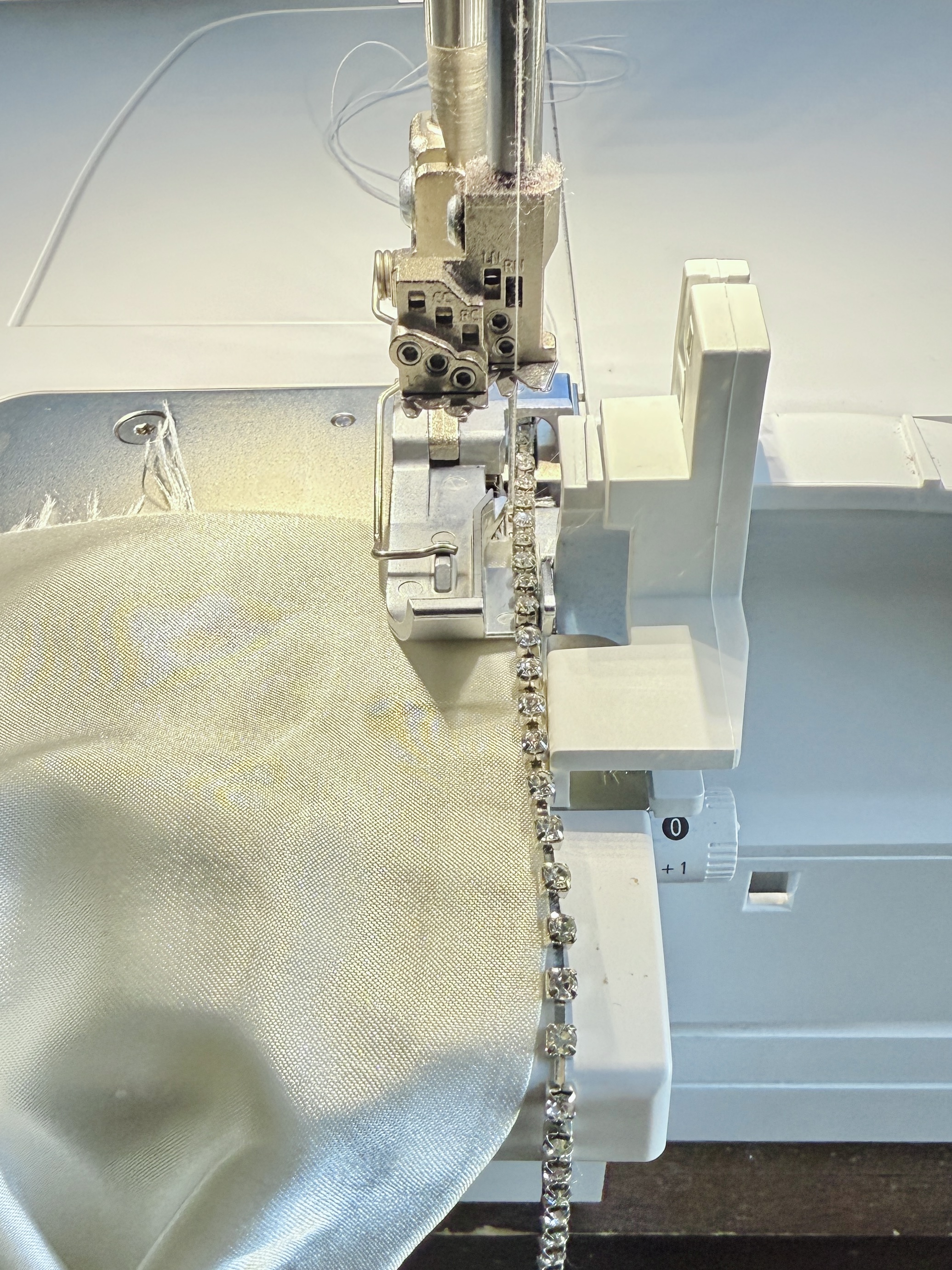Lower the presser foot and sew a few stitches to stabilize the rhinestones. It is now prepped and ready to attach to the fabric.