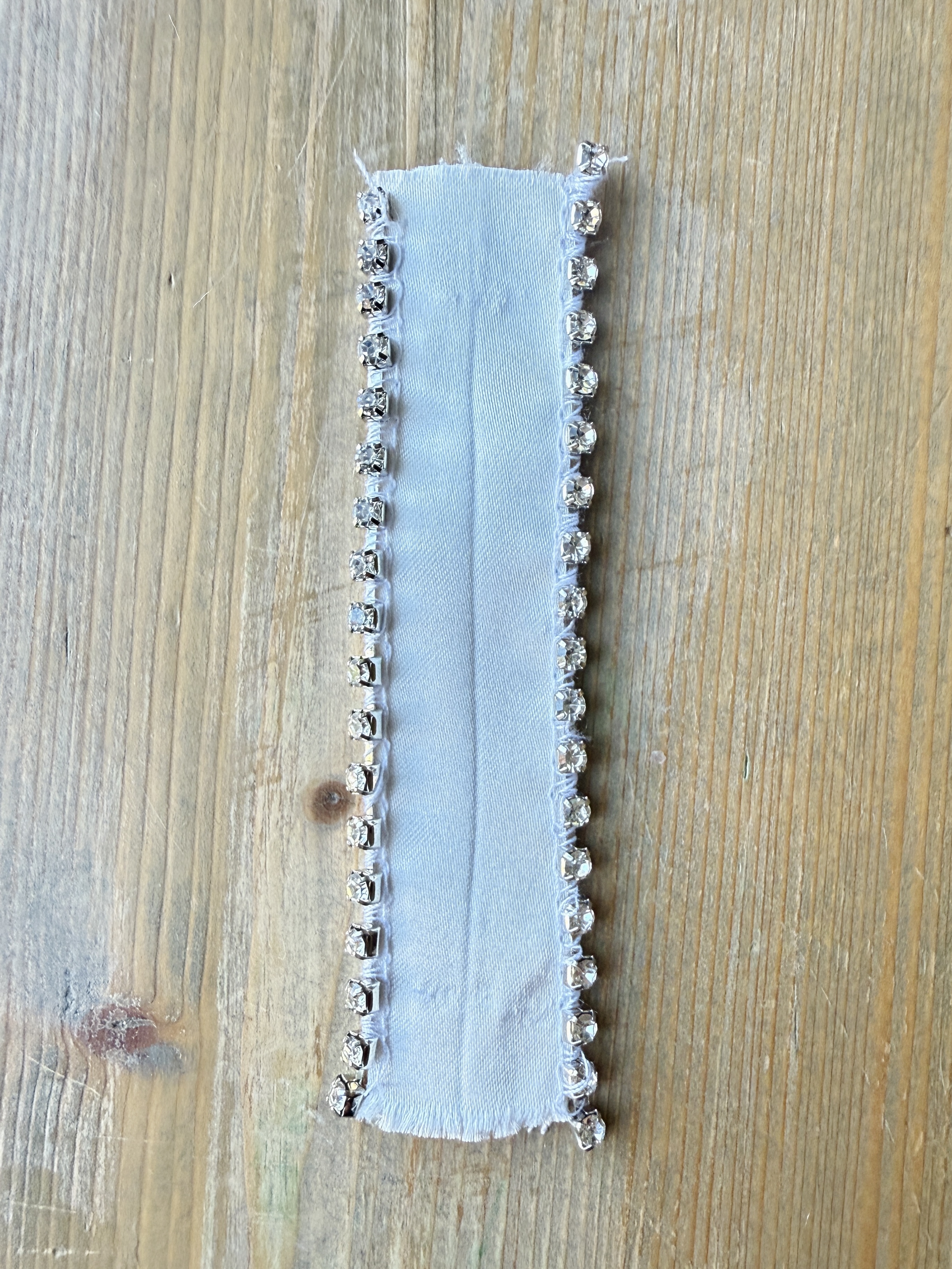 Lower the presser foot and sew a few stitches to stabilize the rhinestones. It is now prepped and ready to attach to the fabric.