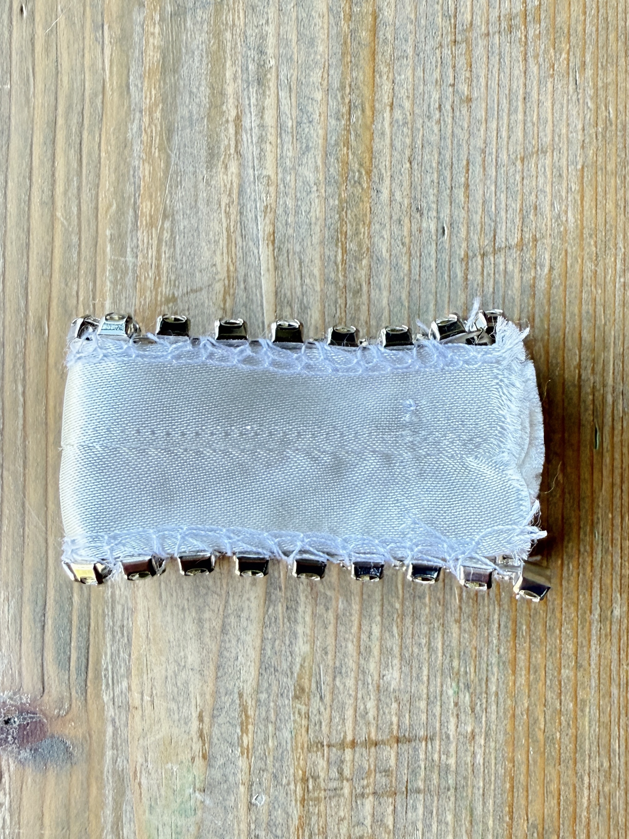 Lower the presser foot and sew a few stitches to stabilize the rhinestones. It is now prepped and ready to attach to the fabric.