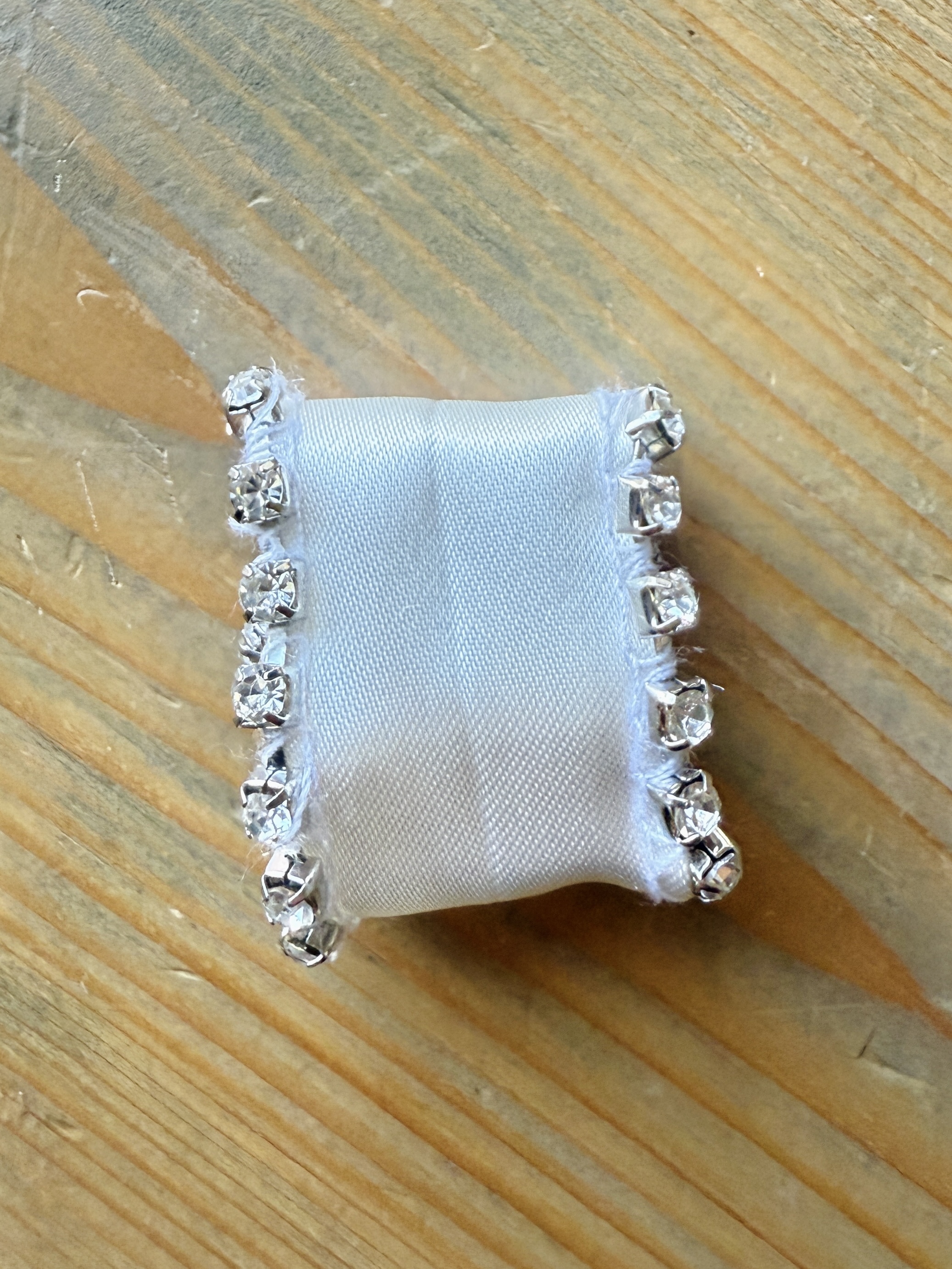 Lower the presser foot and sew a few stitches to stabilize the rhinestones. It is now prepped and ready to attach to the fabric.
