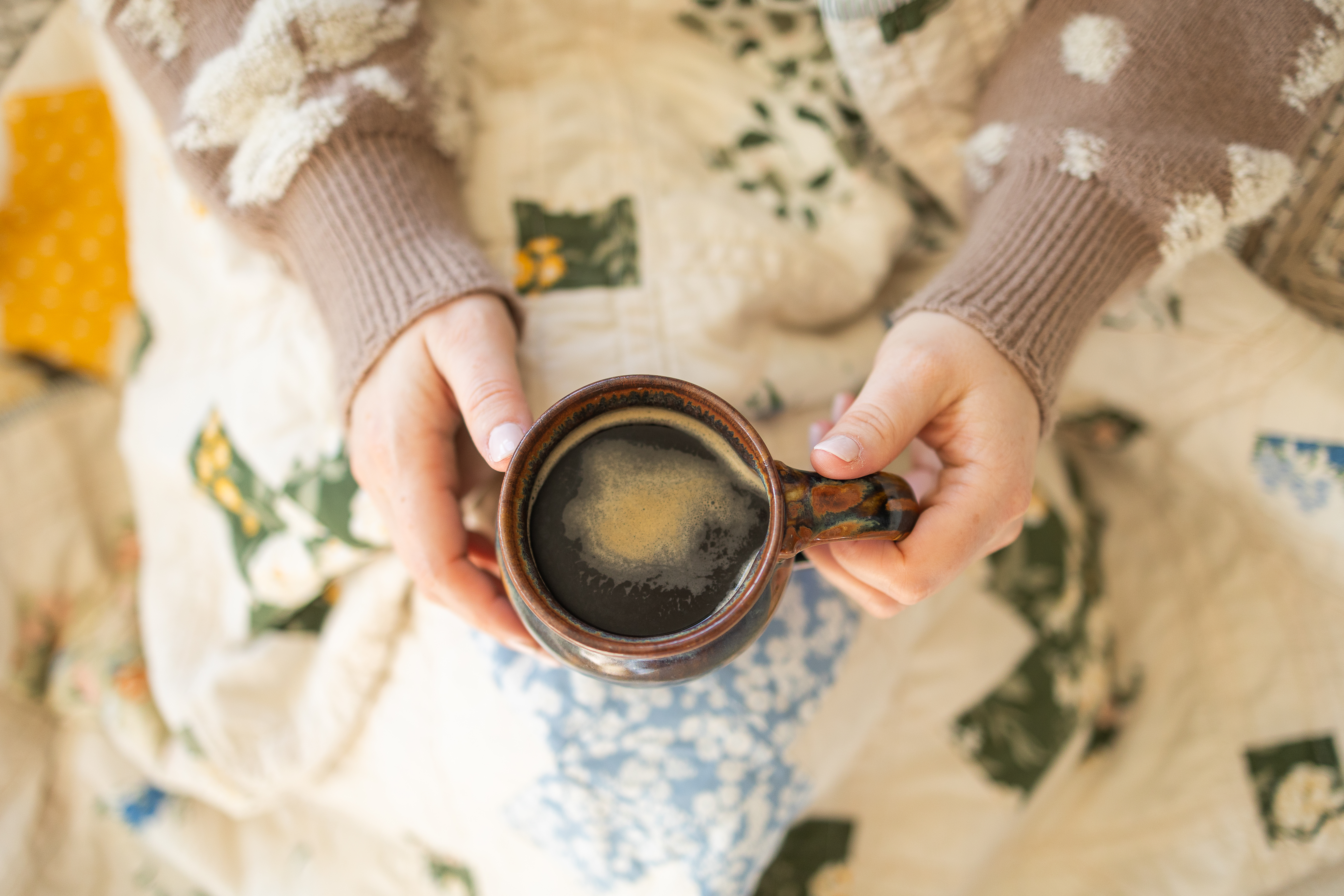Mae Just Sew holding a cup of coffee