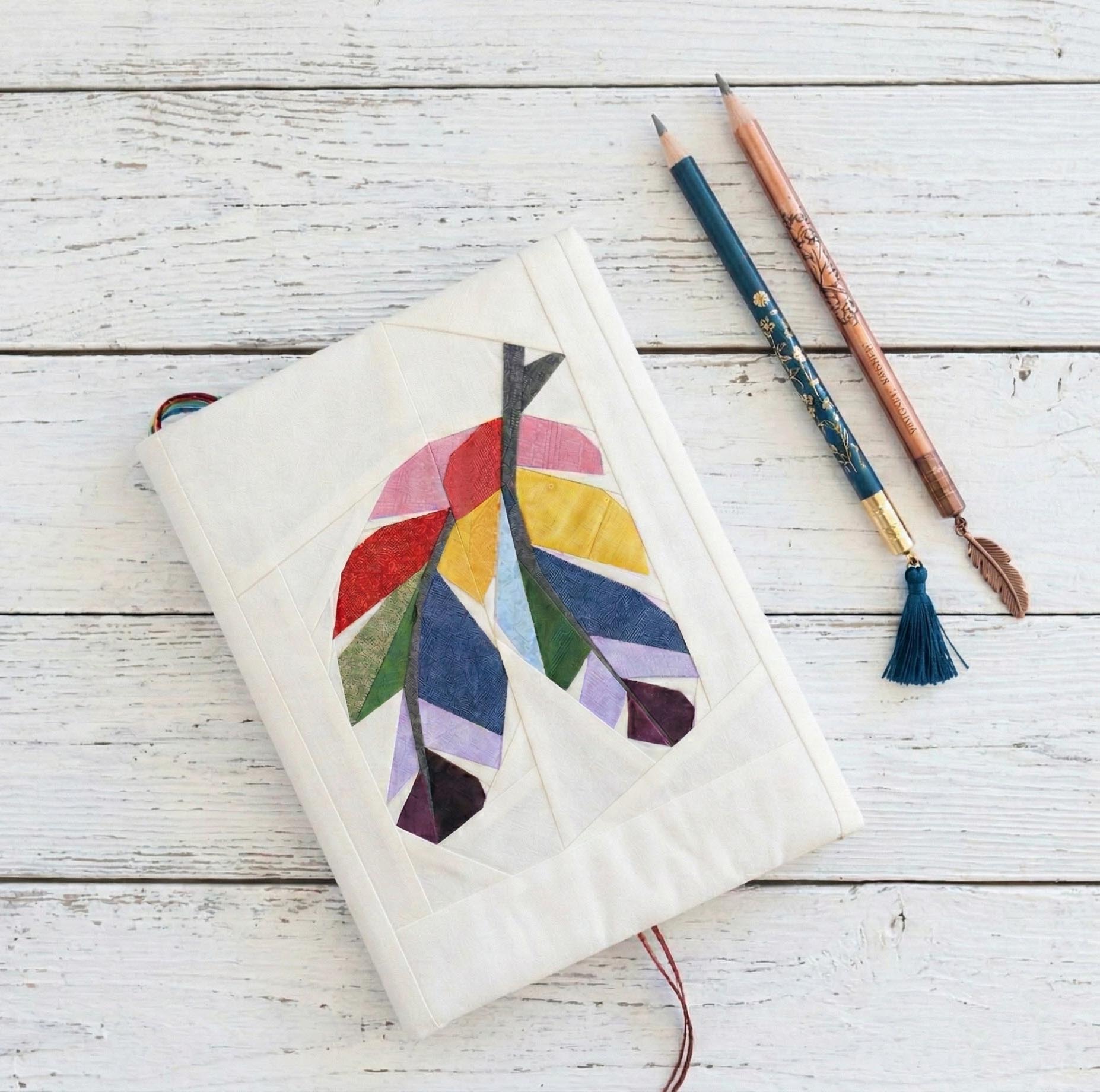 Fabric book cover with feathers quilt block pattern by Joe June and Mae