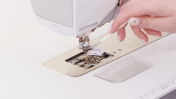 Use a brush to clean the thread catcher